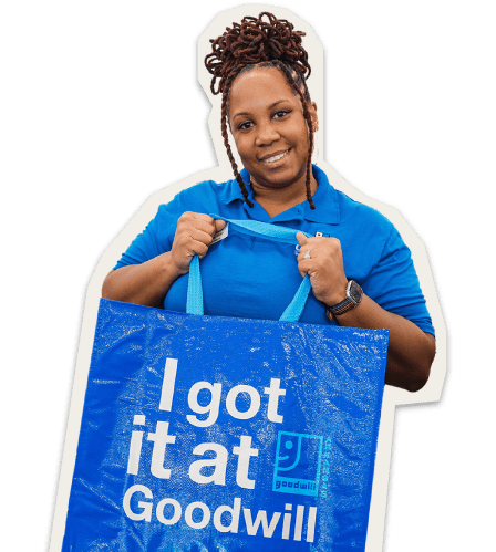Lady holding up an 'i got it at goodwill' tote