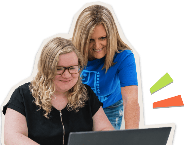Goodwill employee assisting a student on a laptop