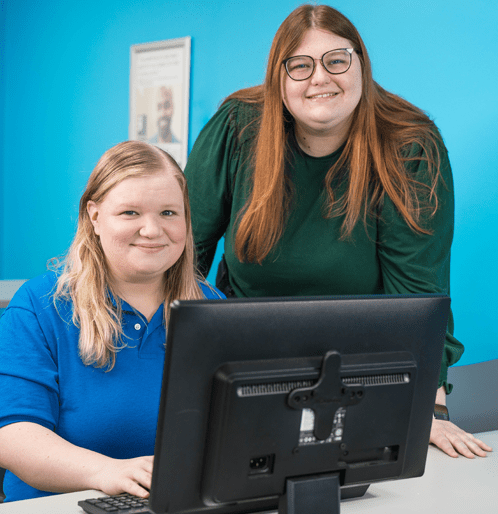 Two women next to each other at a computer