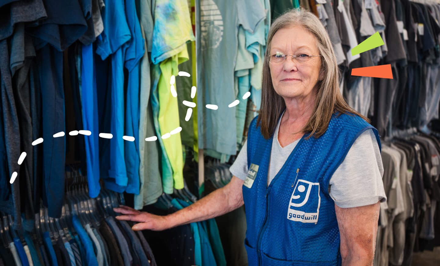 Goodwill employee next to clothes rack