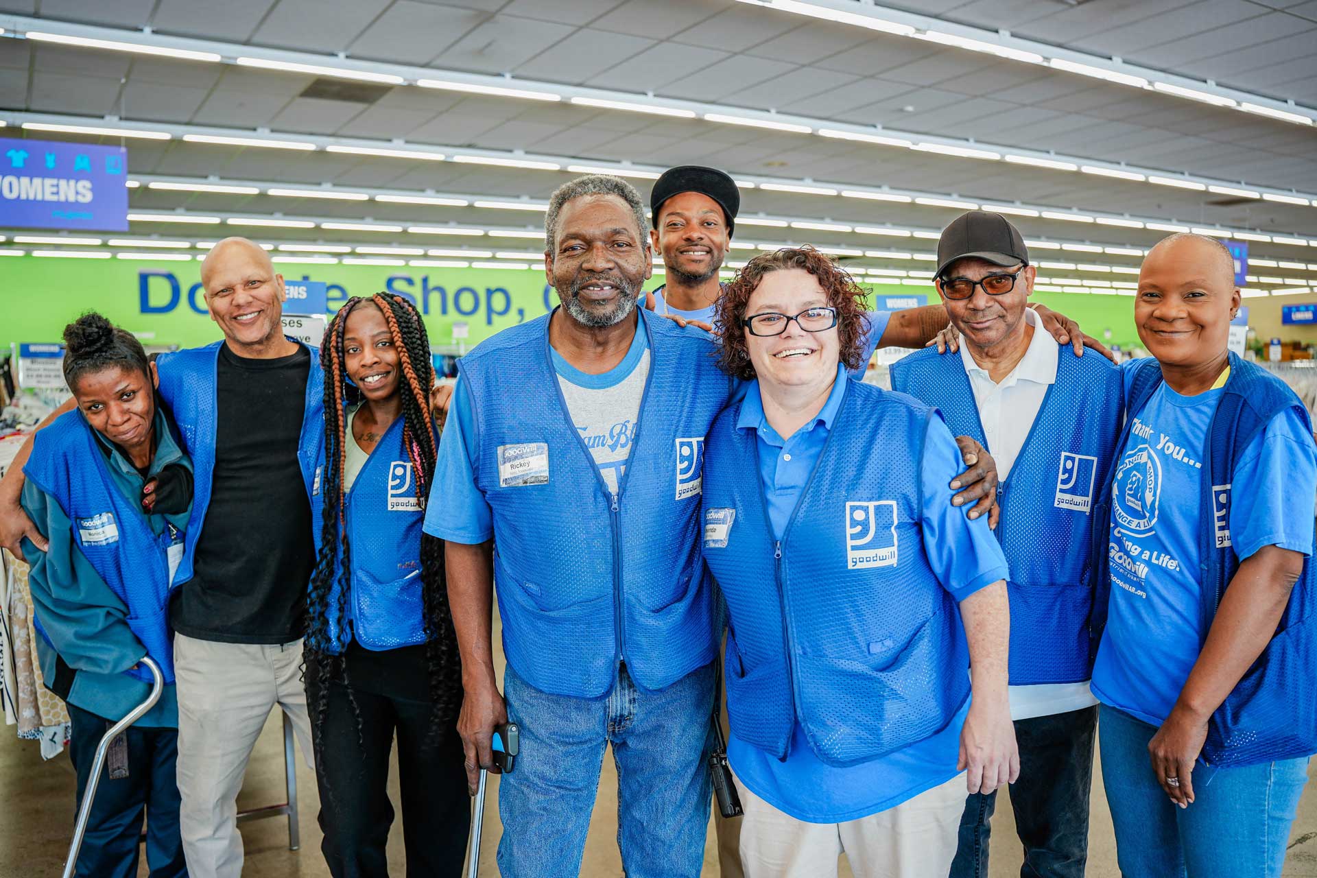 Goodwill employees embracing inside a store
