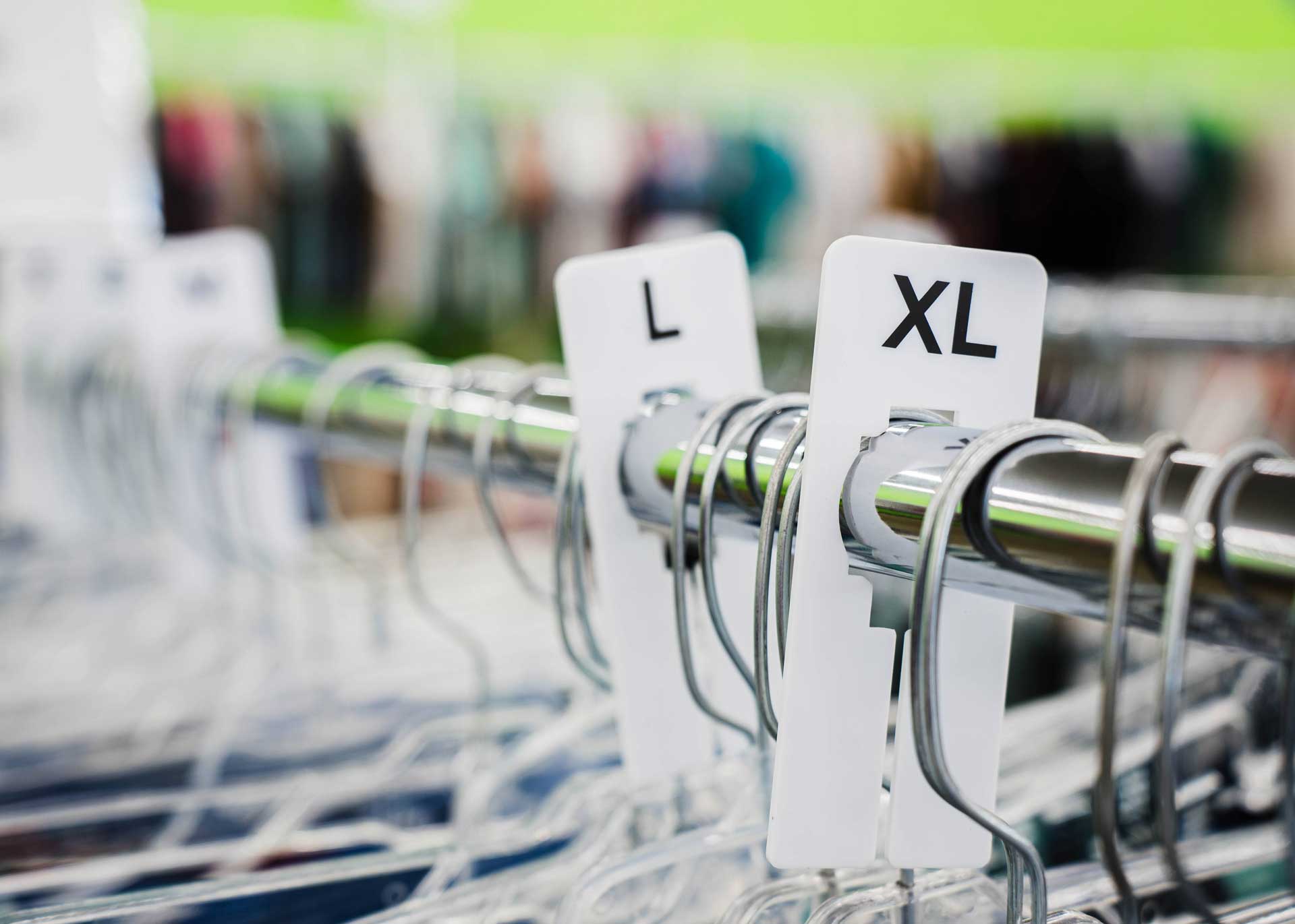 Close up of l and xl clothing on rack